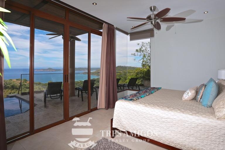 Ocean View Bedroom with Sliding Glass Door and View to Pool