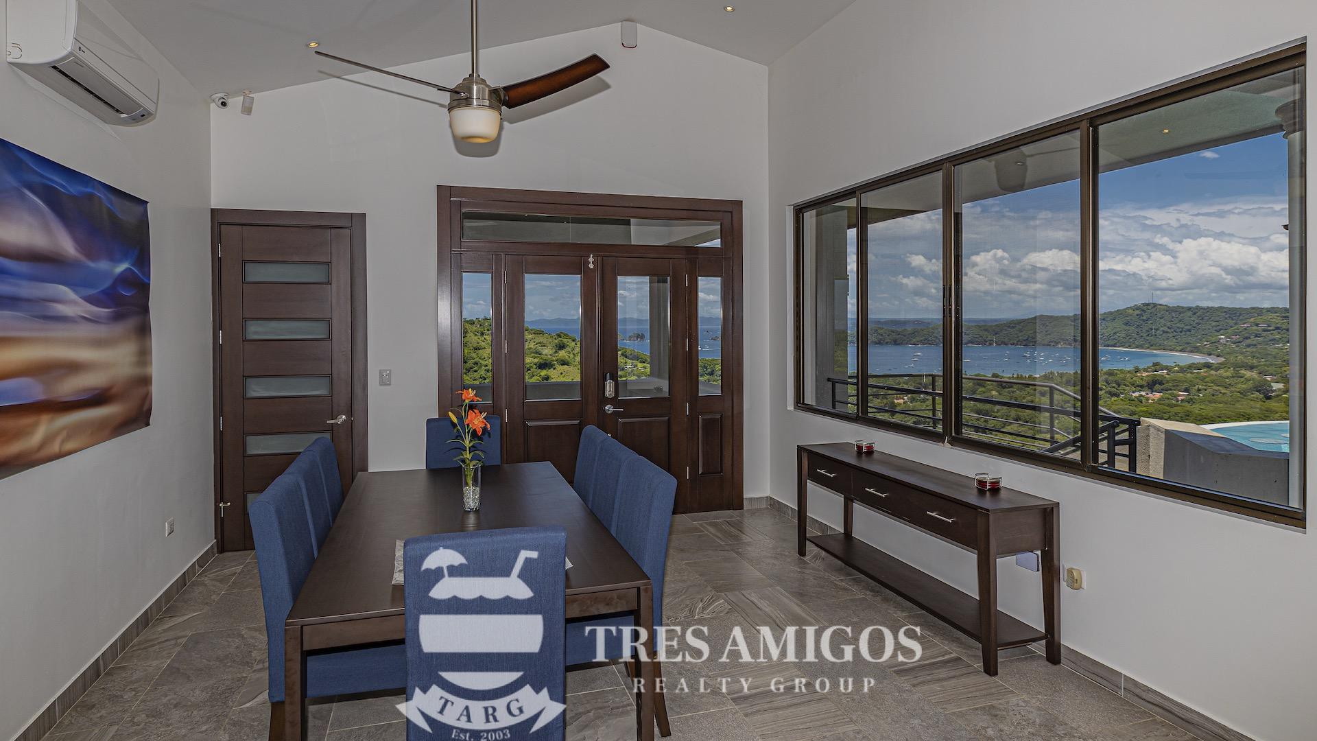 ocean view dining room with air conditioner and glass window