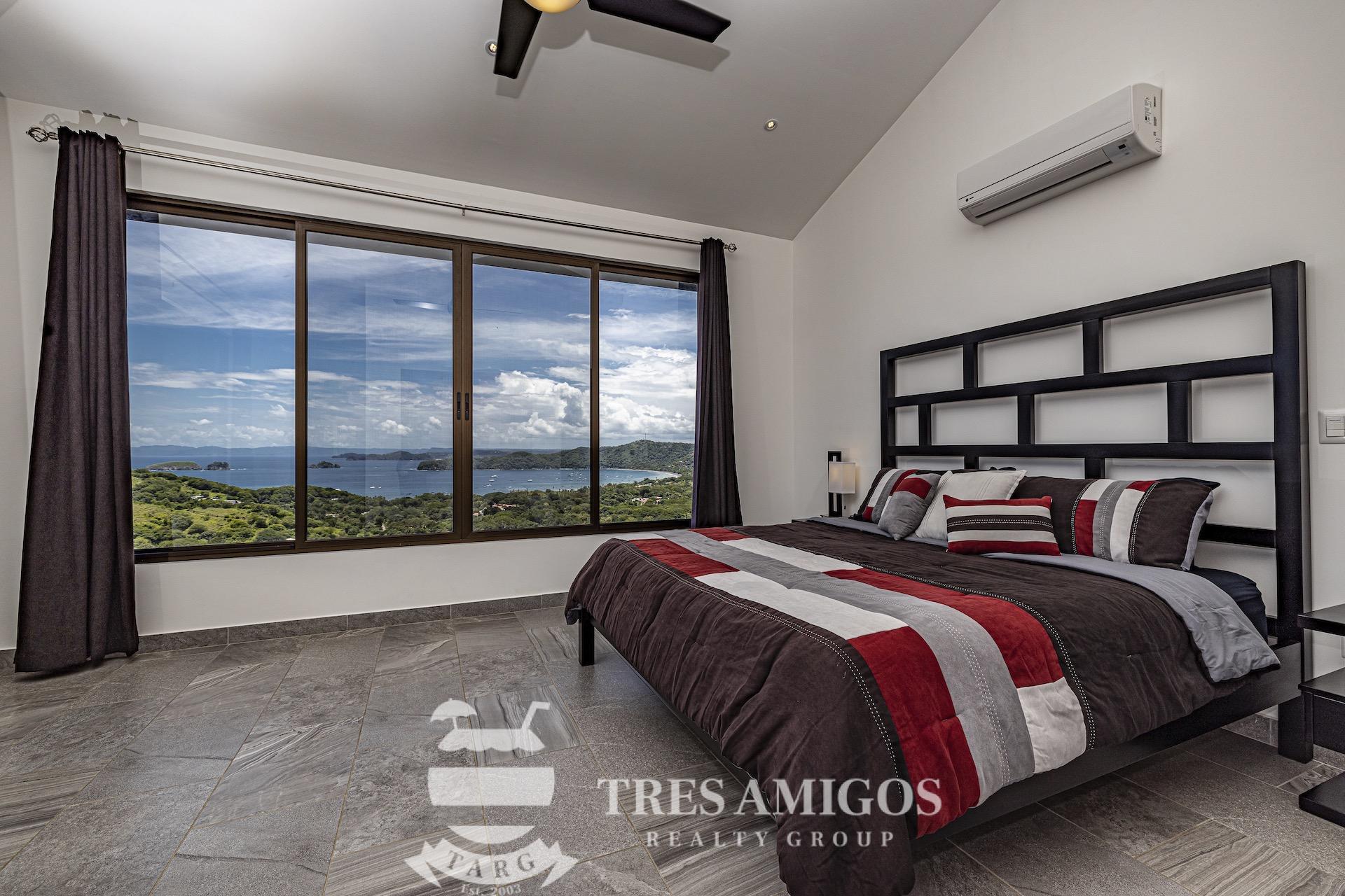 air conditioned bedroom with ceiling fan and glass window