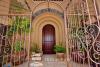 solidwood pachote entry door with wrought iron gates